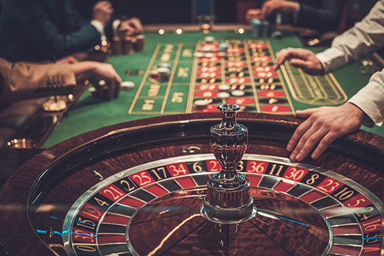 People placing bets at a double zero roulette table
